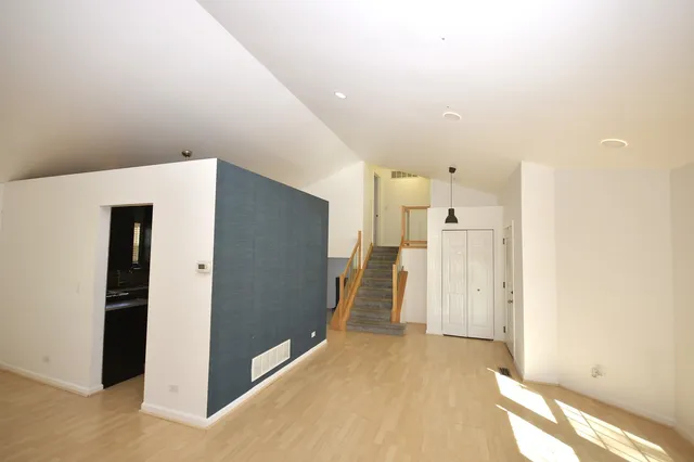 a view of a hallway with a refrigerator
