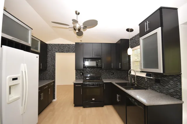 a kitchen with a sink stainless steel appliances and cabinets
