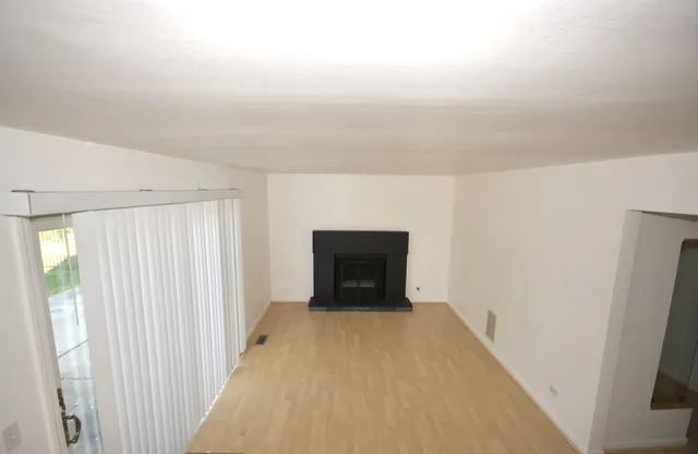 wooden floor in an empty room with a fireplace