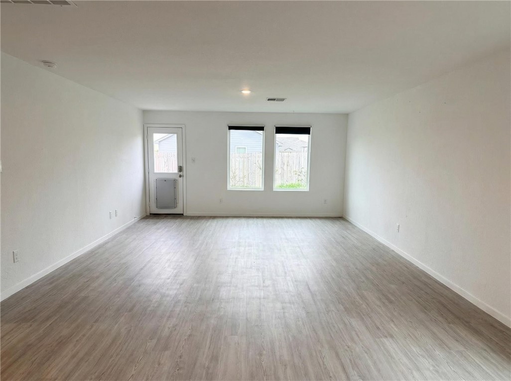 9201 Wilde Way Corpus Christi, TX 78410 - Photo 4 of 21 an empty room with wooden floor and windows