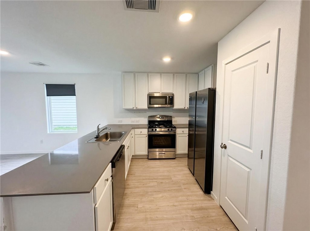 9201 Wilde Way Corpus Christi, TX 78410 - Photo 10 of 21 a kitchen with kitchen island granite countertop stainless steel appliances cabinets a sink and a window
