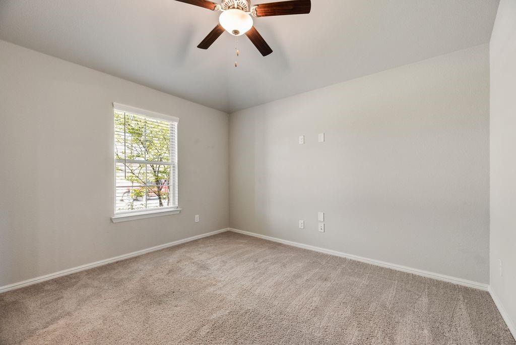 14216 Aberavon Drive Pilot Point, TX 76258 - Photo 5 of 19 Carpeted room with neutral wall tones and a ceiling fan with integrated lighting