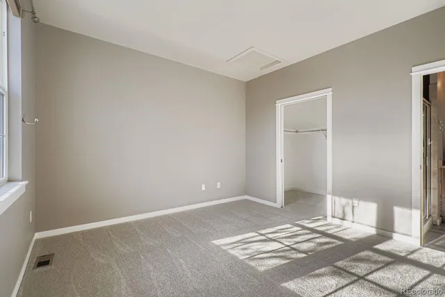a view of a bedroom with wooden floor and bathroom