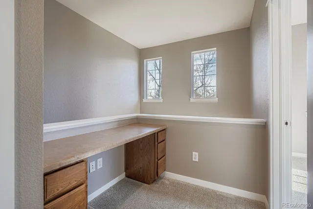 a room with a wooden floor and window