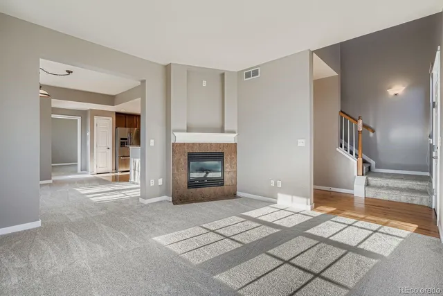 a view of a livingroom with wooden floor and a fireplace