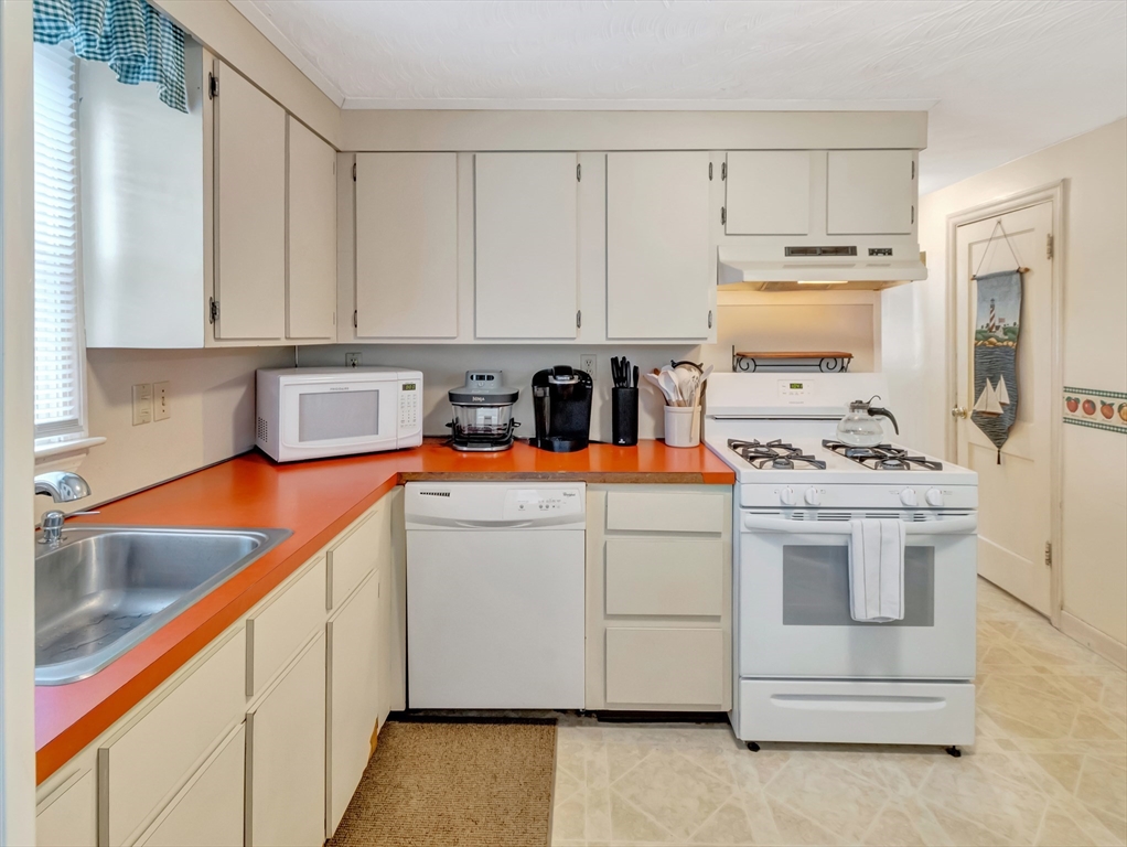5 G Street Hull, MA 02045 - Photo 20 of 41 a kitchen with appliances a sink and cabinets