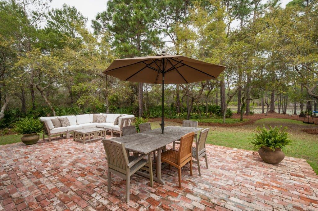 97 Spotted Dolphin Road Santa Rosa Beach, FL 32459 - Photo 3 of 32 a view of backyard with seating space and trees
