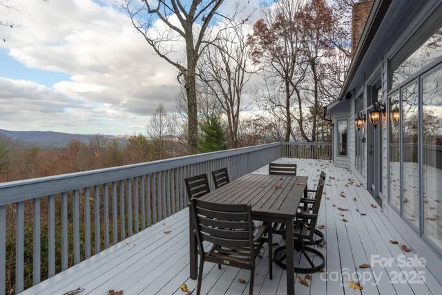 a view of a patio with table and chairs and wooden floor