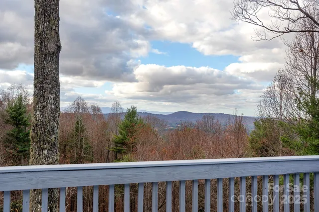 a view of a balcony with trees