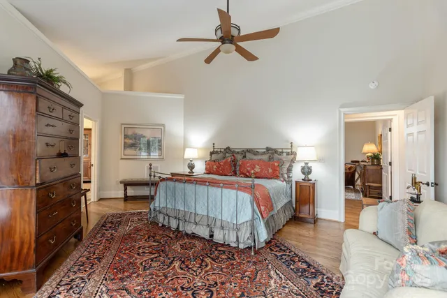 a bedroom with a bed and a chandelier