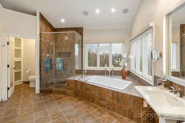 a spacious bathroom with a tub and a sink