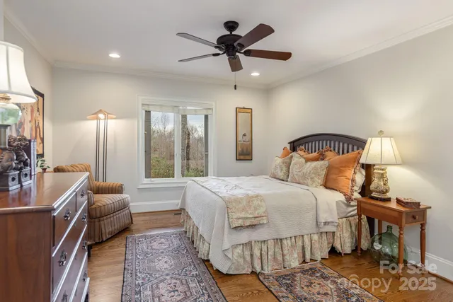 a bedroom with a bed and ceiling fan