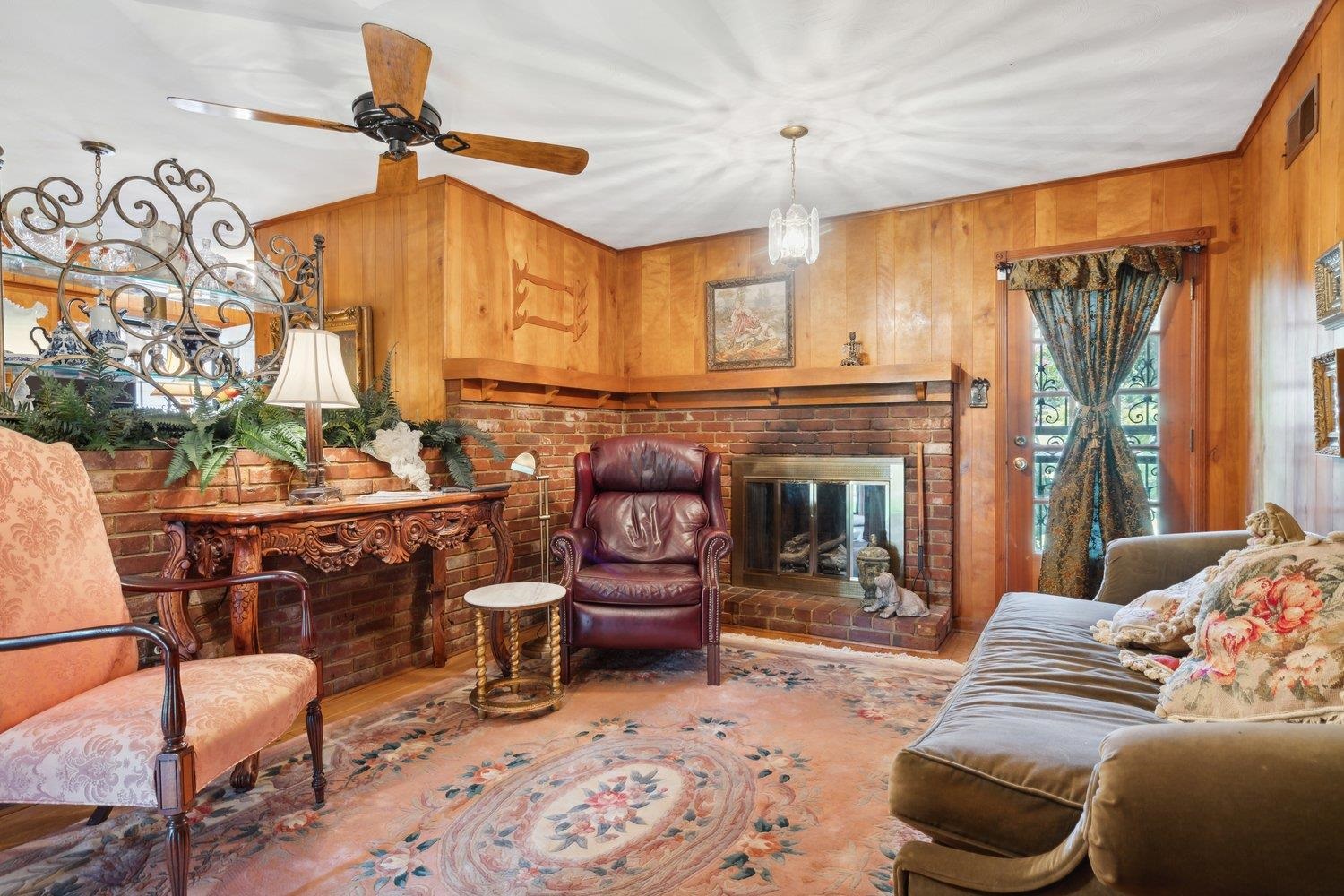 3158 Keats Road Memphis, TN 38134 - Photo 11 of 21 Den with wood walls, a fireplace, and ceiling fan
