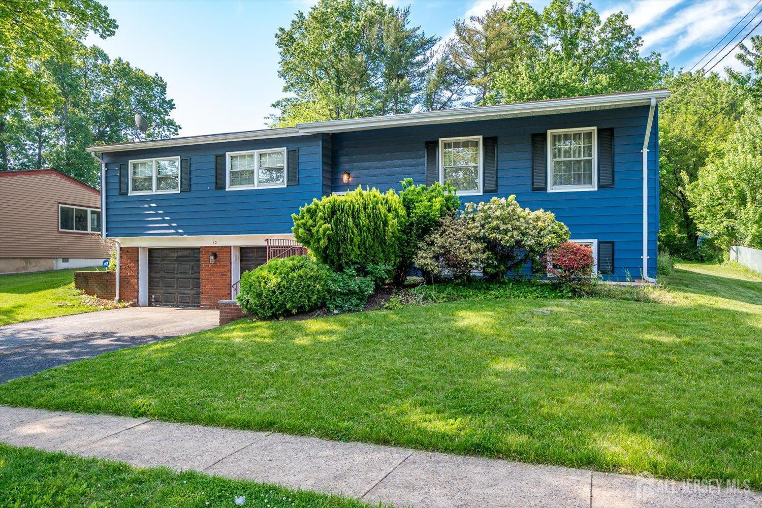 12 Gales Road Edison, NJ 08837 - Photo 2 of 35 a front view of a house with a yard and garage