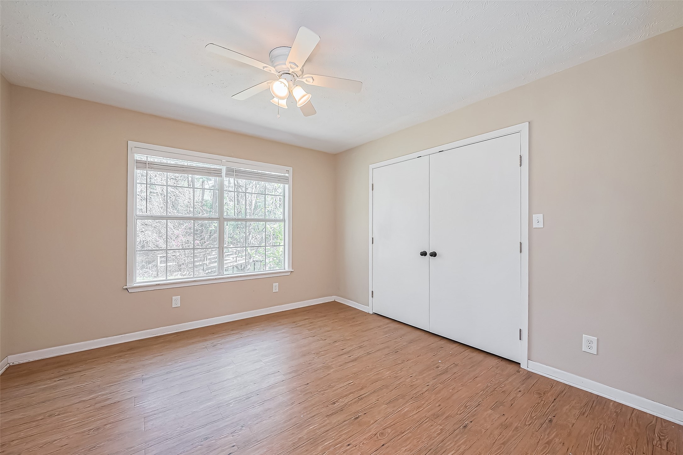 14 Veronica Lane Huntsville, TX 77340 - Photo 21 of 50 a view of an empty room with wooden floor and a window
