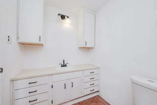 a bathroom with a sink a mirror and a vanity