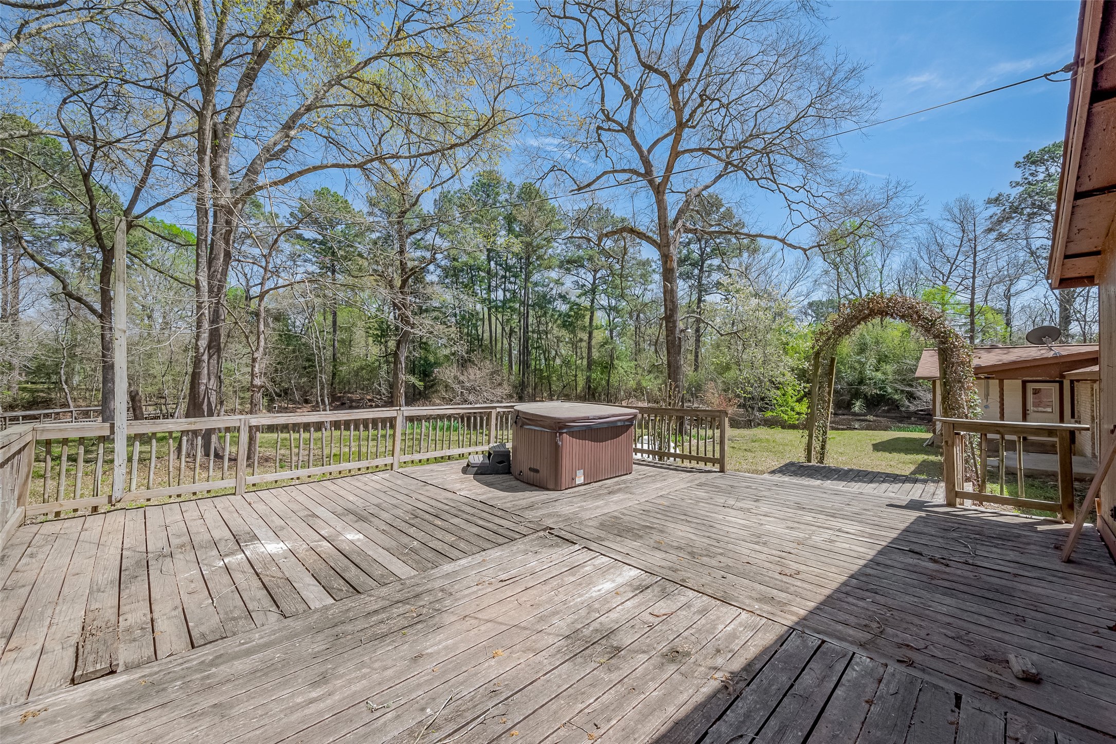 14 Veronica Lane Huntsville, TX 77340 - Photo 46 of 50 a view of a patio with wooden floor and fence next to a yard