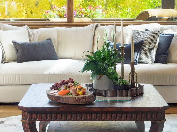 a room with painting on the wall and a potted plant