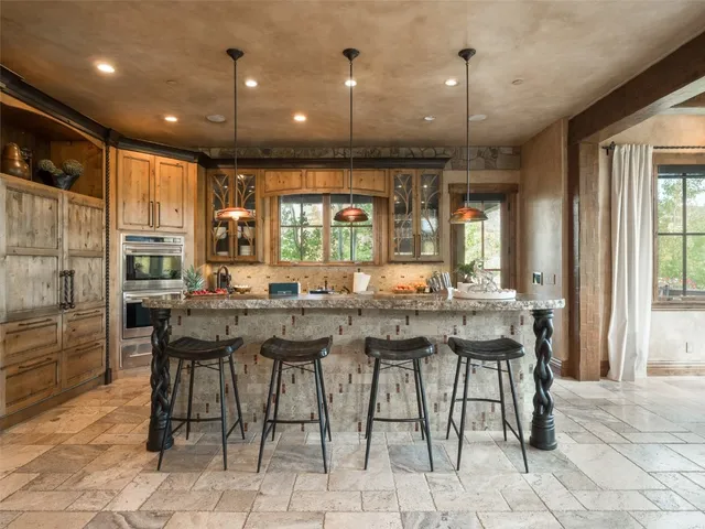 a kitchen with stainless steel appliances granite countertop a stove a sink and a granite counter tops