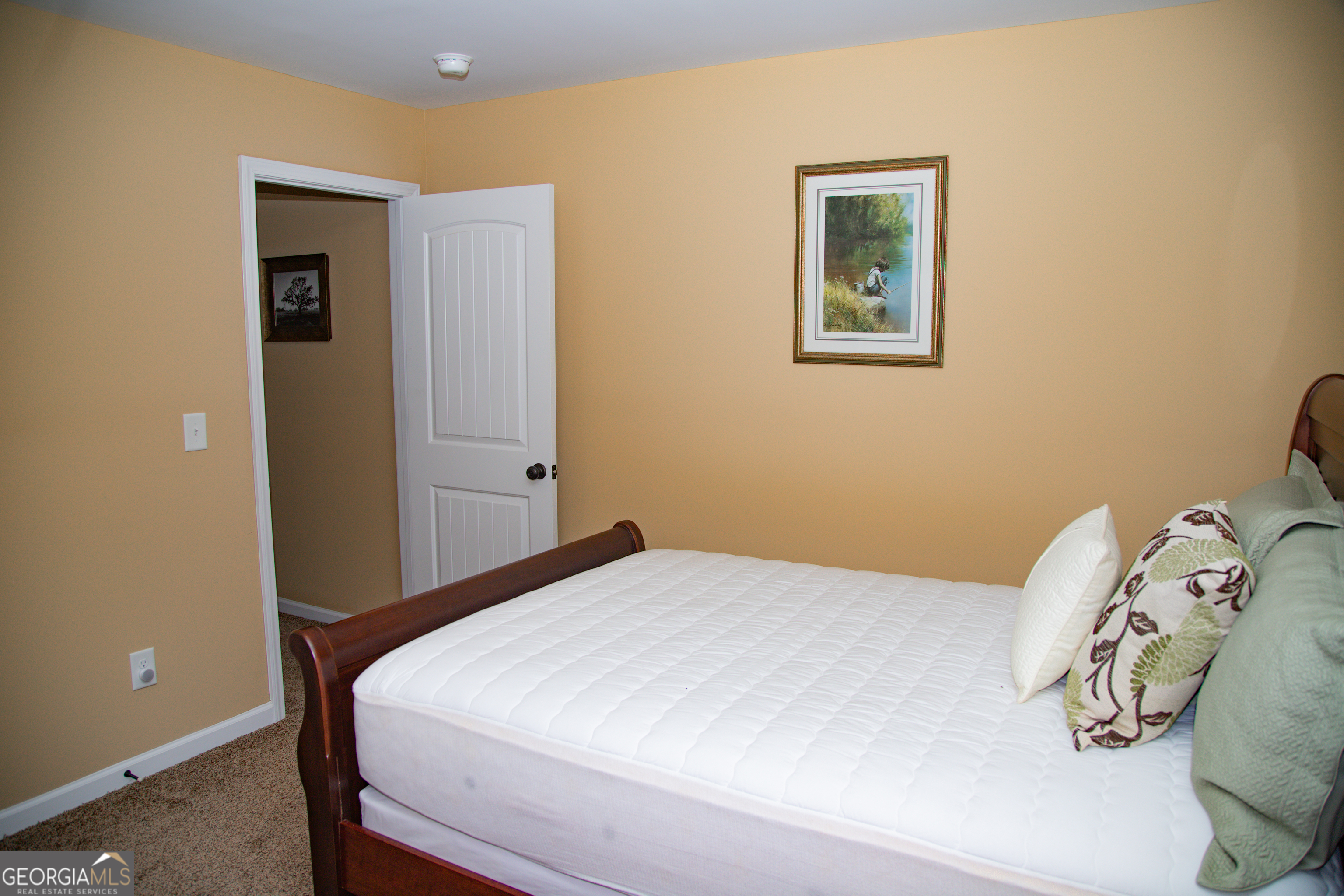 149 Bridle Path Griffin, GA 30224 - Photo 23 of 47 a bedroom with a bed and a wall painting