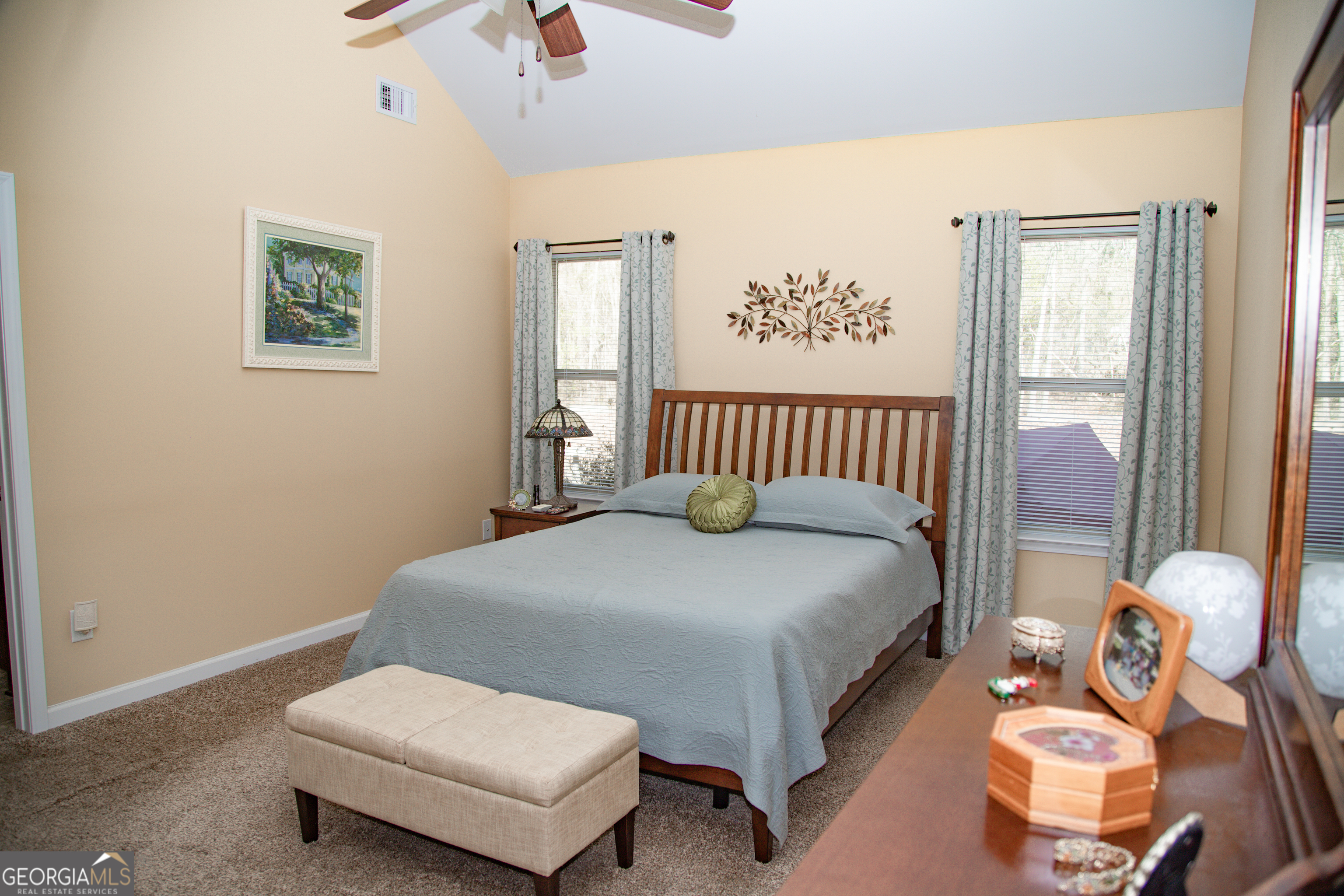 149 Bridle Path Griffin, GA 30224 - Photo 30 of 47 a spacious bedroom with a bed and a chandelier