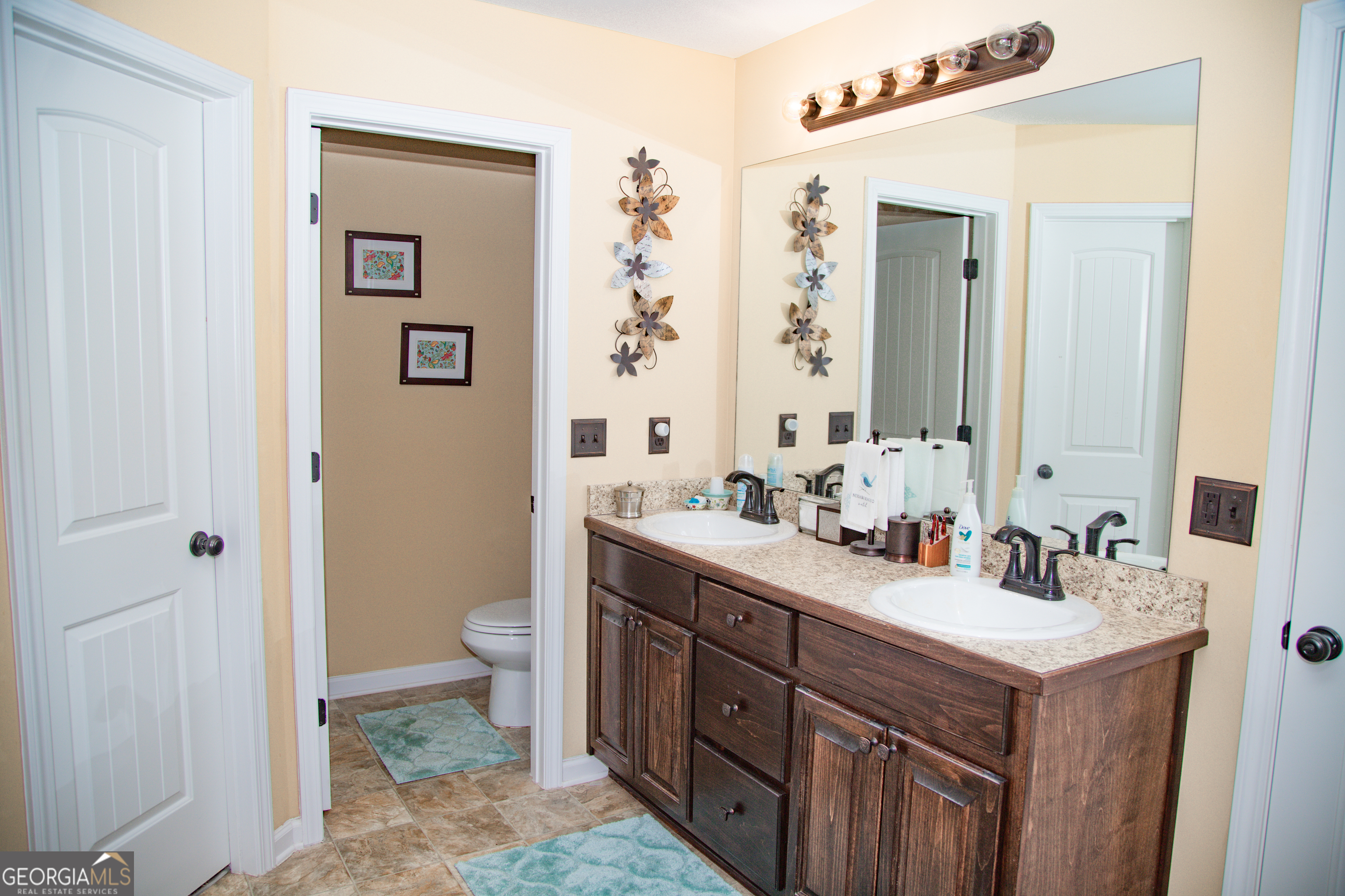 149 Bridle Path Griffin, GA 30224 - Photo 35 of 47 a bathroom with a double vanity sink mirror and toilet