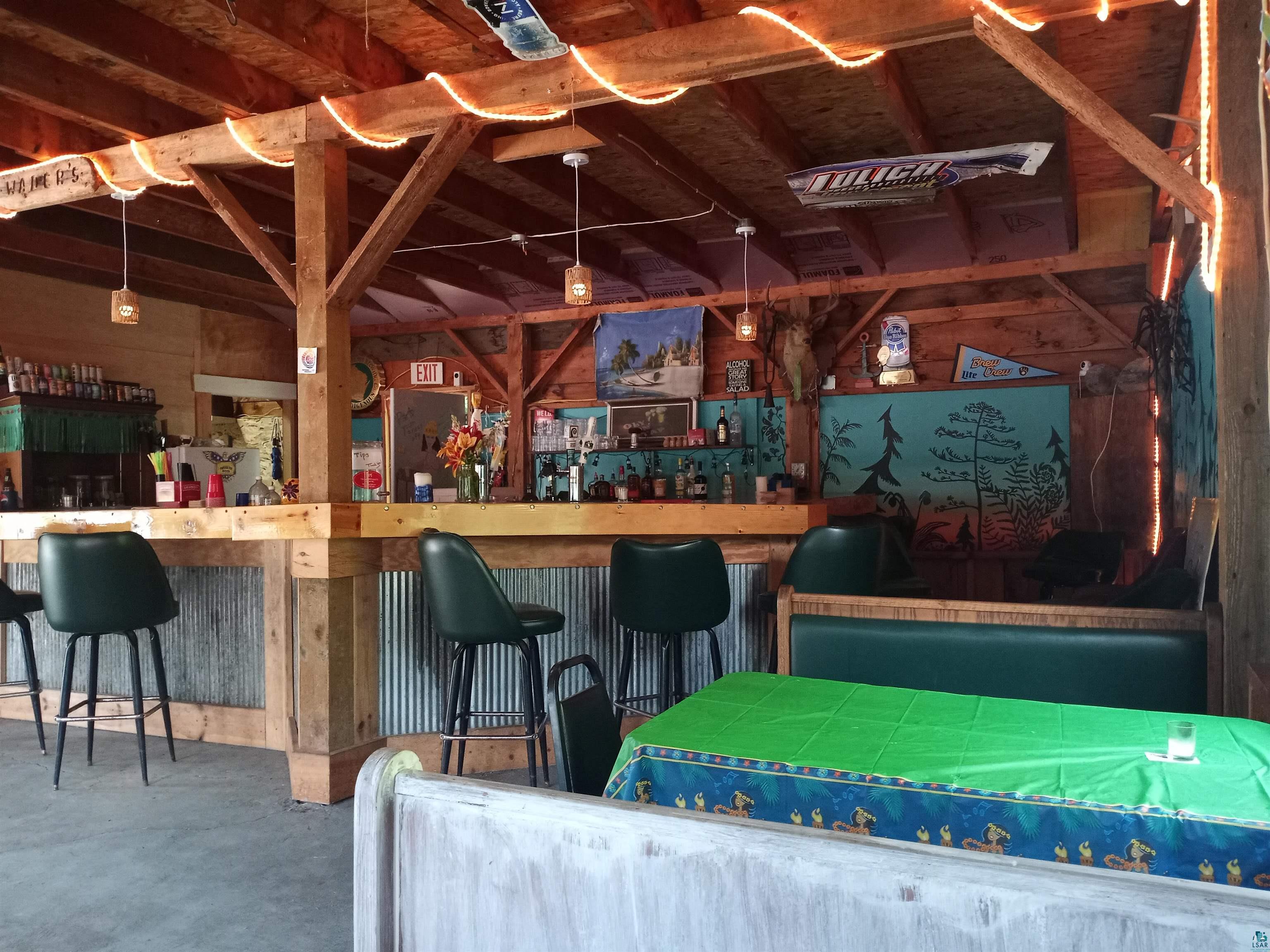 22270 County Highway Cornucopia, WI 54827 - Photo 2 of 4 Interior space featuring concrete floors and indoor bar