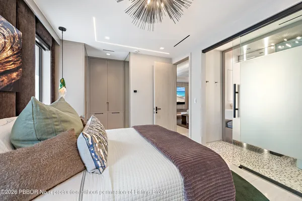 a bedroom with a bed and a large window