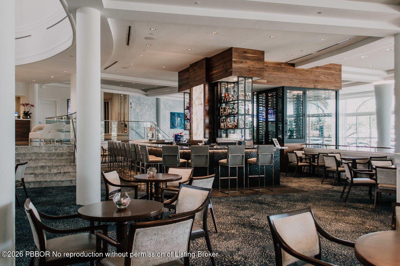3501 Captains Way, Unit 3501 Jupiter, FL 33477 - Photo 26 of 41 a living room with fireplace furniture and a large window