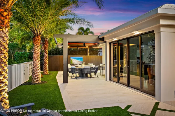 a large kitchen with stainless steel appliances a large center island a stove and a cabinets