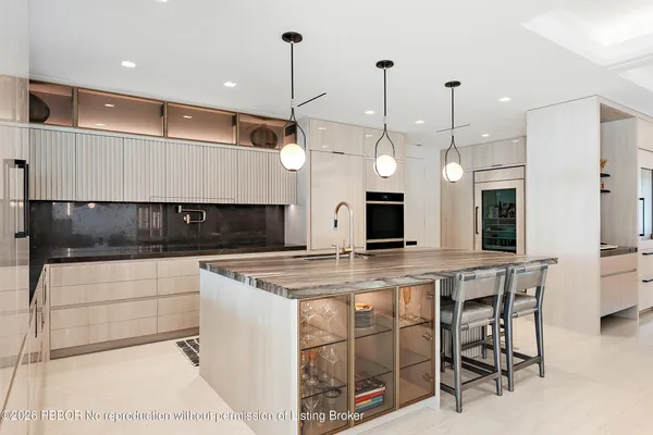 a kitchen with kitchen island granite countertop a table and chairs in it