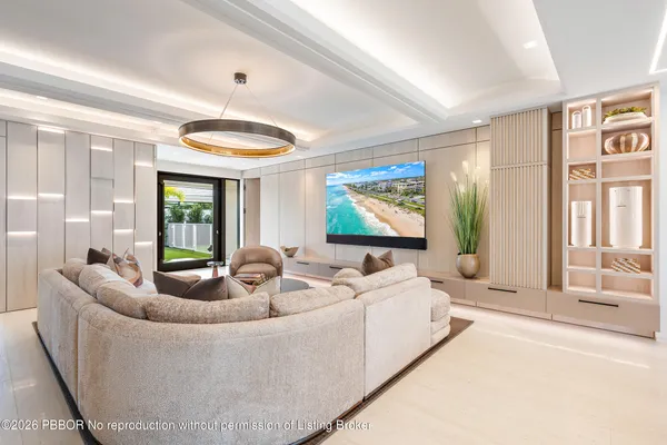 a living room with furniture and a floor to ceiling window