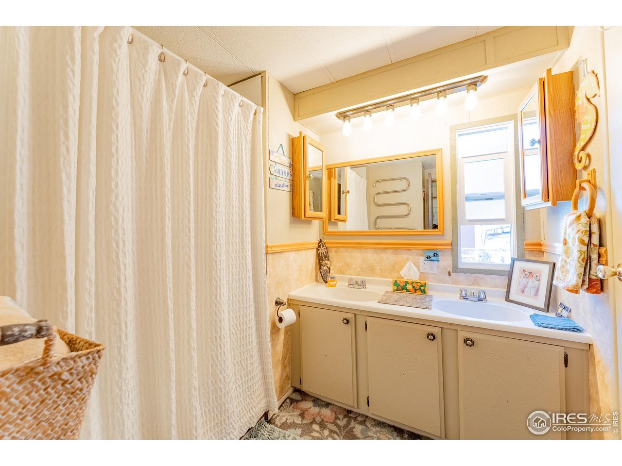 2500 East Harmony Road, Unit 456 Fort Collins, CO 80528 - Photo 12 of 22 a bathroom with a double vanity sink and a mirror