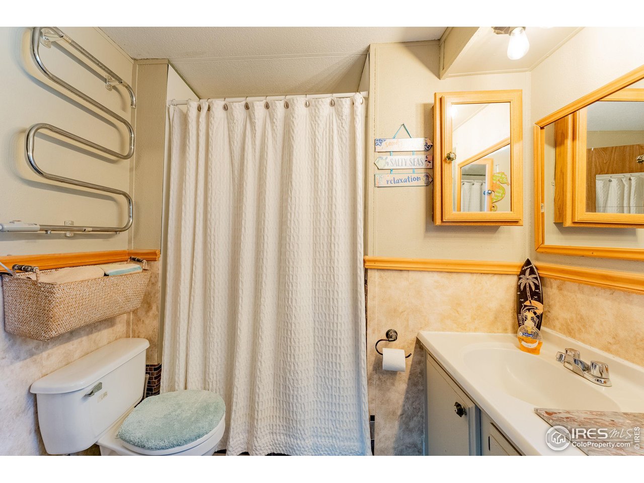 2500 East Harmony Road, Unit 456 Fort Collins, CO 80528 - Photo 13 of 22 a bathroom with a sink a mirror and a shower curtain