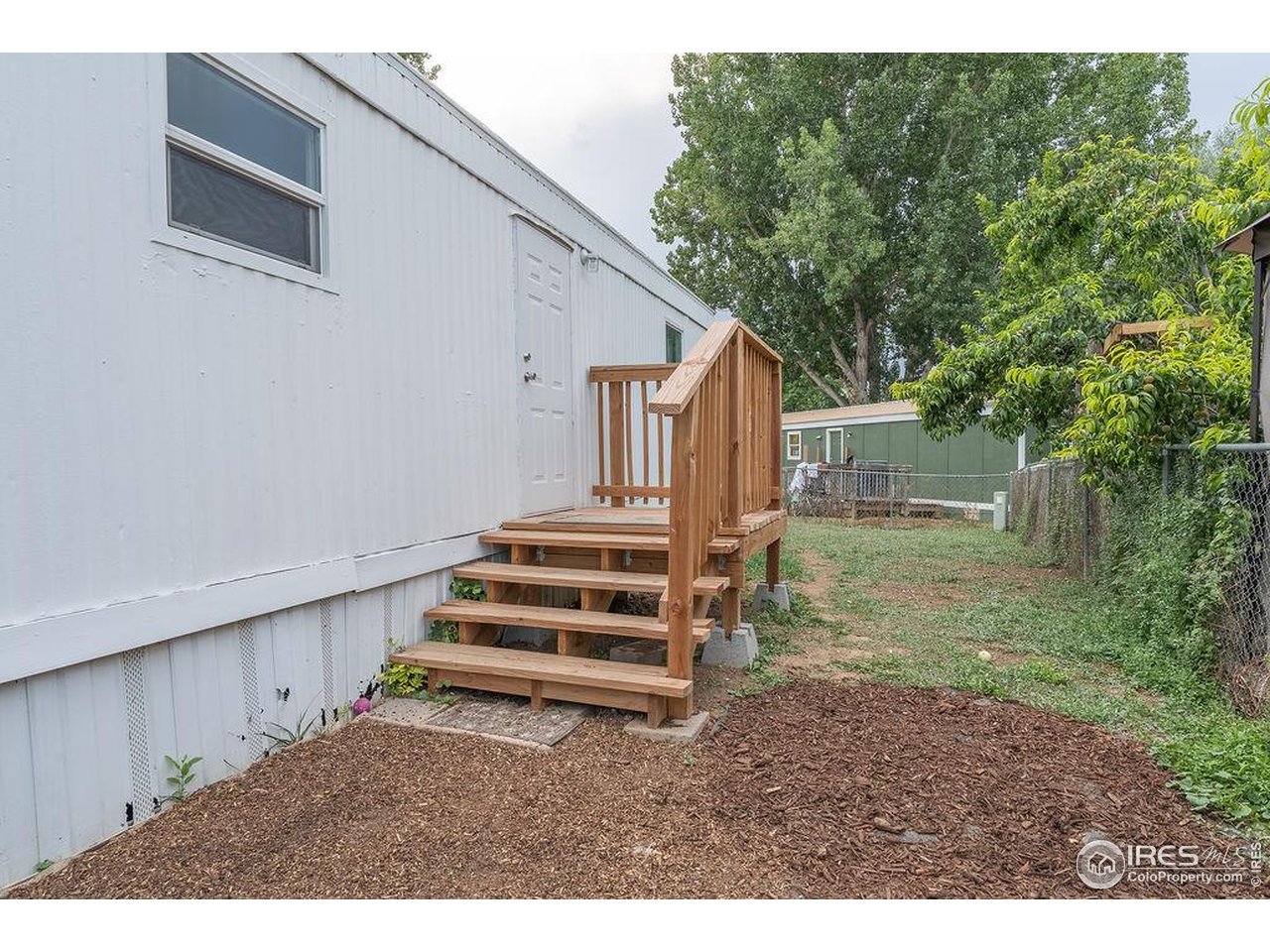 2500 East Harmony Road, Unit 456 Fort Collins, CO 80528 - Photo 21 of 22 a backyard of a house with wooden floor
