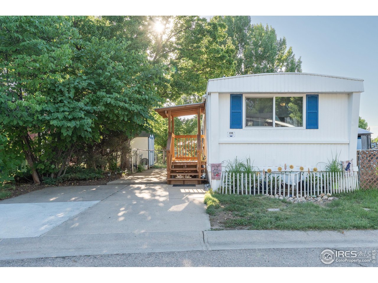 2500 East Harmony Road, Unit 456 Fort Collins, CO 80528 - Photo 3 of 22 a view of a house with a wooden deck and a yard