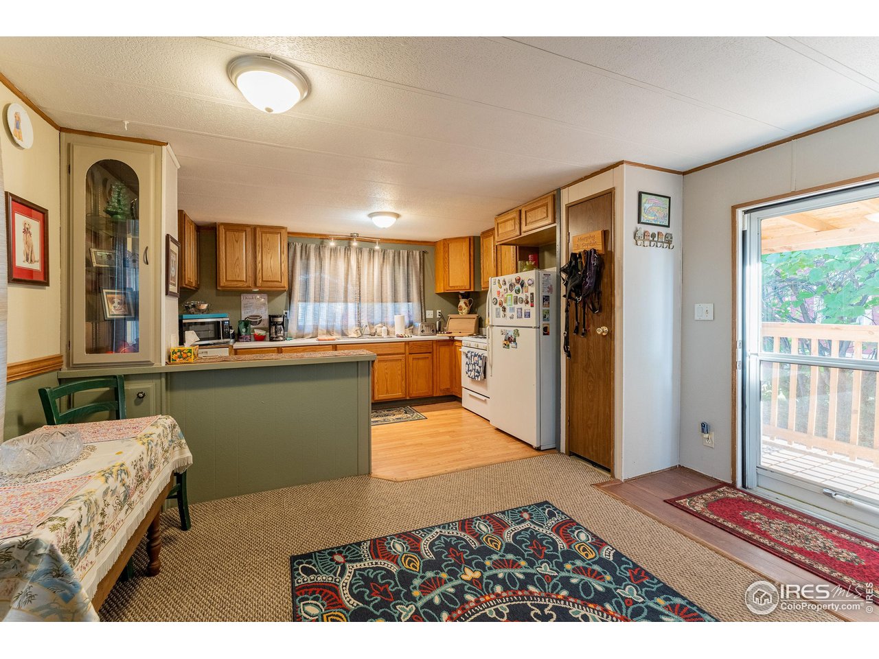 2500 East Harmony Road, Unit 456 Fort Collins, CO 80528 - Photo 7 of 22 a kitchen with stainless steel appliances kitchen island granite countertop a refrigerator and stove