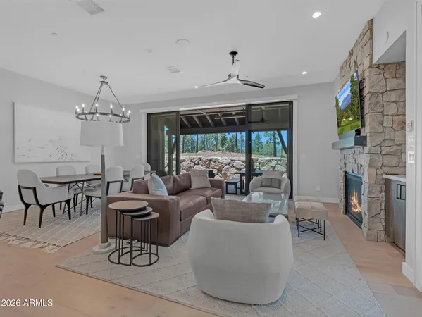 a living room with furniture a chandelier and a fireplace