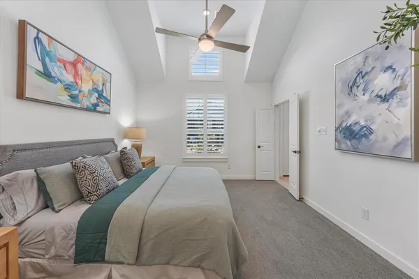 a bedroom with a bed and a painting on the wall