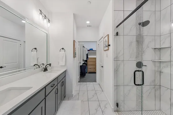 a spacious bathroom with a sink and mirror