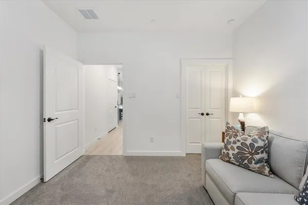 a living room with furniture and white walls