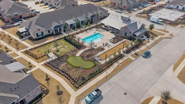 an aerial view of multiple houses with a big yard