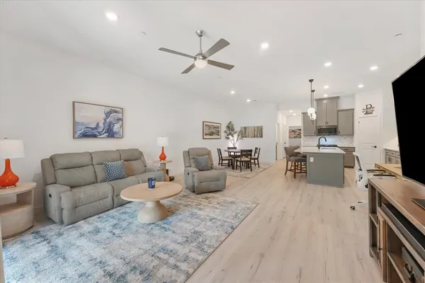 a living room with furniture and kitchen view