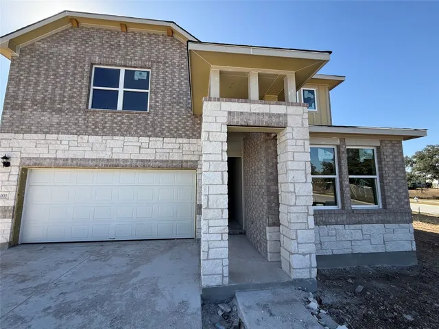 a front view of a house with a garage