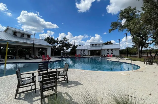 a view of a house with swimming pool and sitting area