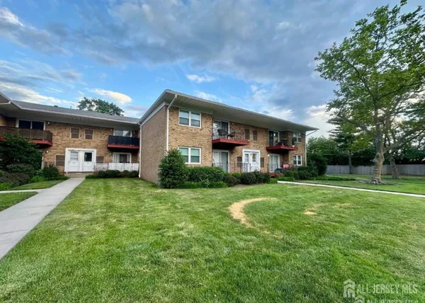 a front view of a house with a yard table and chairs
