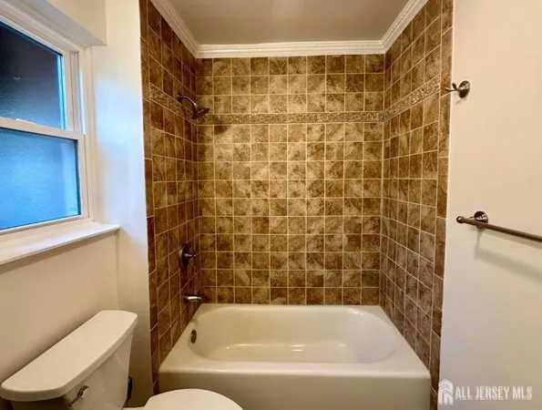 a bathroom with a bathtub and toilet