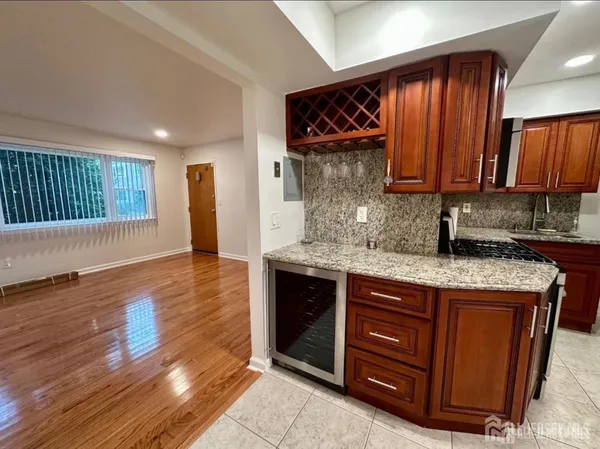 a kitchen with stainless steel appliances granite countertop a sink stove and cabinets