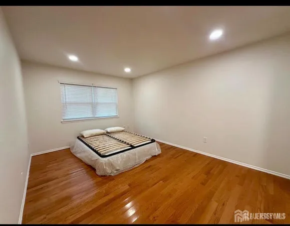 a view of wooden floor and windows in a room