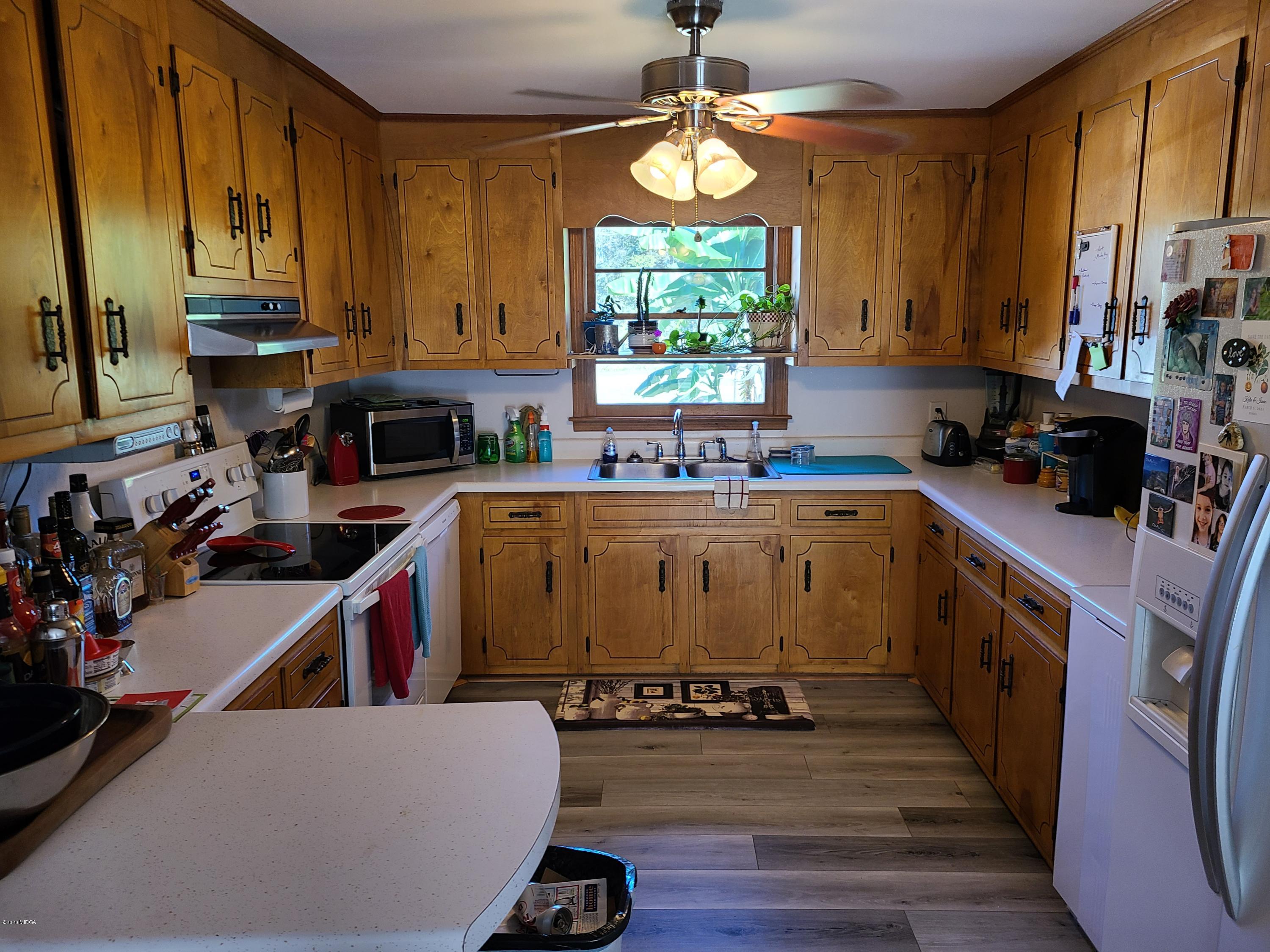 1172 Cumslo Road Macon, GA 31211 - Photo 22 of 33 a kitchen with a sink a stove and cabinets